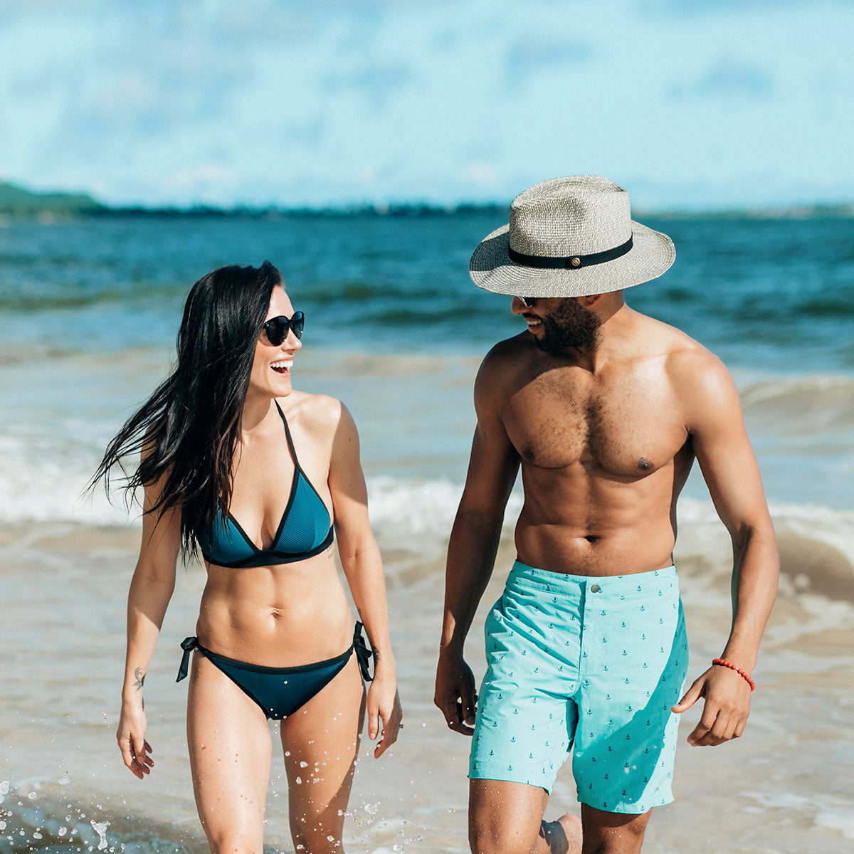 Steph in the Moontide Jacquard Booster Triangle Bikini and Blair in the Boto Anchors Boardshort